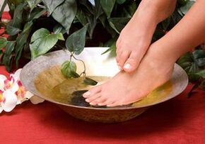Bath with household soap against the mushroom of the foot